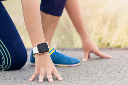 woman in gesture ready to run on road during evening