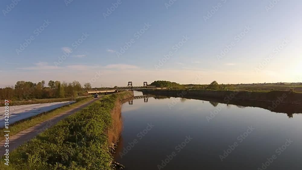 Fly up above River at Sunset. Great video for placing a text or logo, or for using as an establishing shot in your project. You can reverse or speed up the video for a greater effect. Fly up above River at Sunset. Great video for placing a text or logo, or for using as an establishing shot in your project. You can reverse or speed up the video for a greater effect.