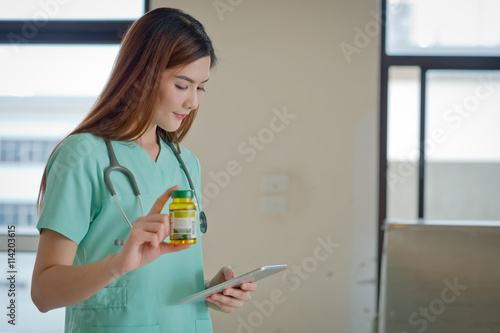 Young doctor with a box of pills in hand. Healthcare business