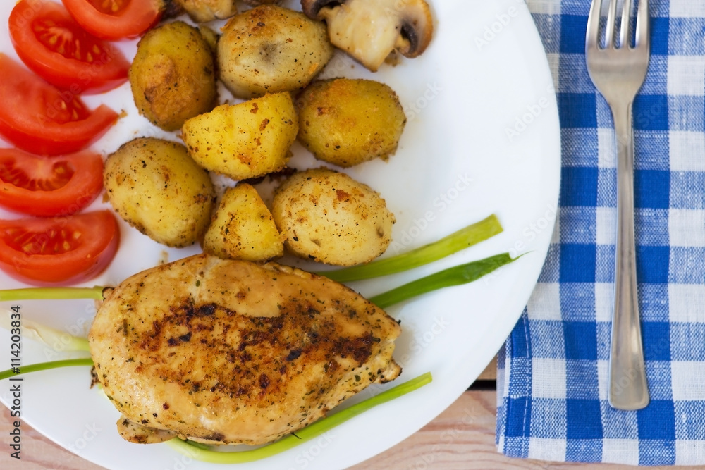 fried chicken fillet with potatoes tomatoes and mushrooms fried chicken fillet with potatoes tomatoes and mushrooms
