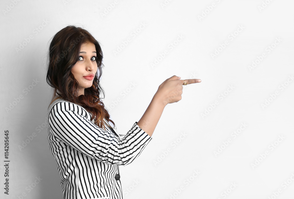 Attractive beautiful young Indian business woman pointing her fi Attractive beautiful young Indian business woman pointing her fi