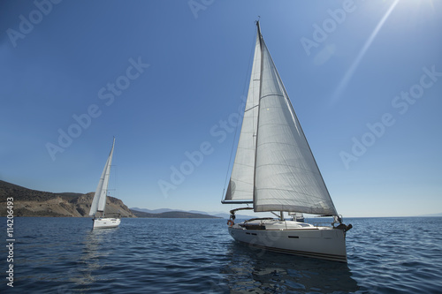 Two luxury yachts sailing on the sea. © De Visu