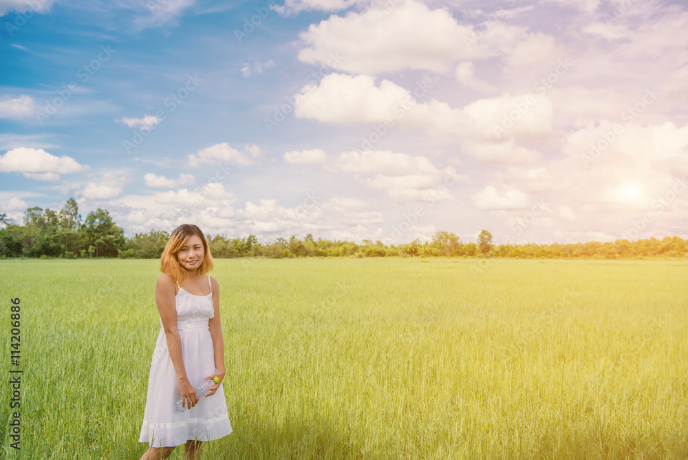 Woman drinking water on green meadow background.blue sky. Woman drinking water on green meadow background.blue sky.