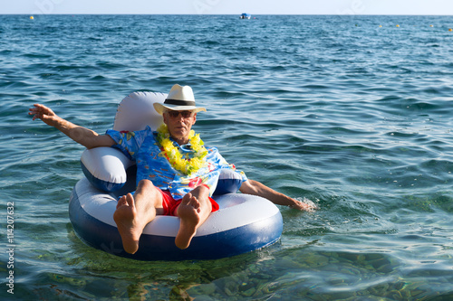 Senior man floating in sea