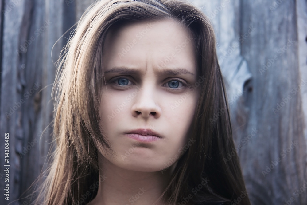 Portrait of a young girl on a wooden background Portrait of a young girl on a wooden background