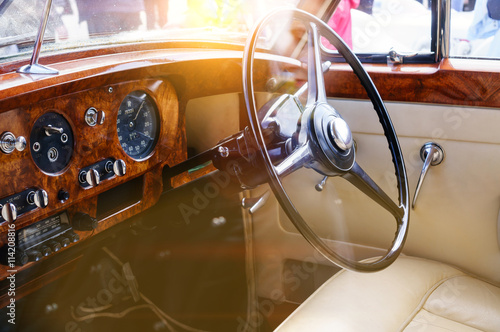 Interior of a classic vintage car with sun glare © smspsy