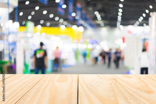 Wood table top on blur exhibition background