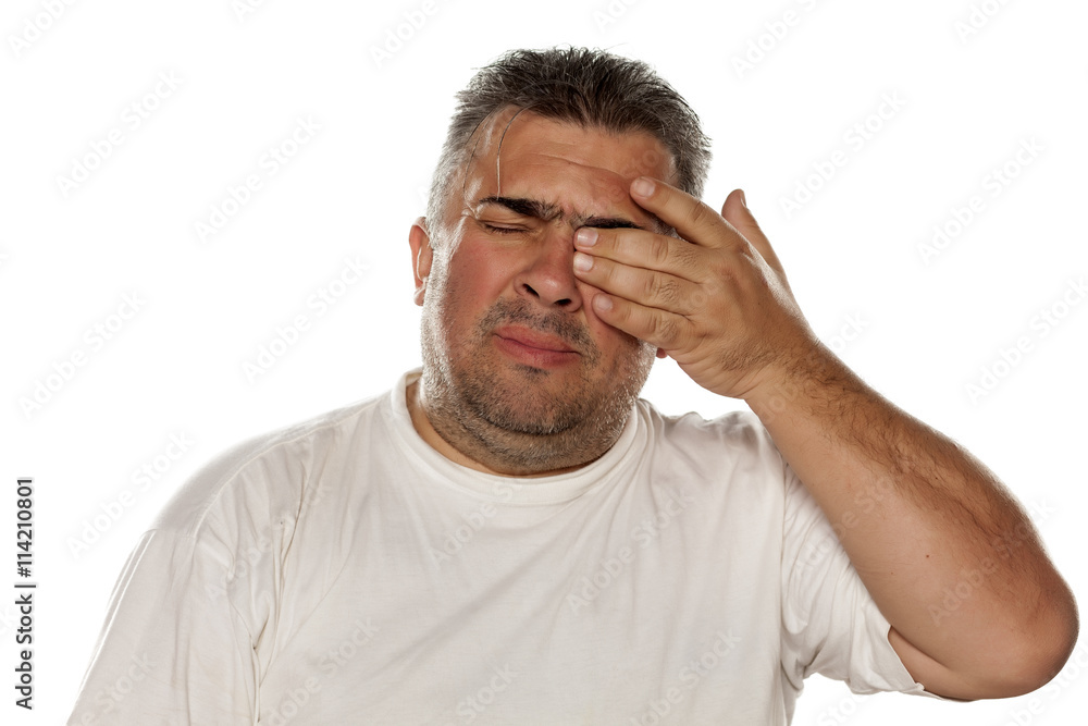 sad man has a pain in the eye sad man has a pain in the eye