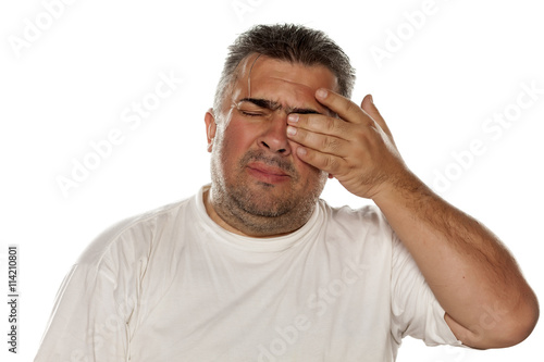 sad man has a pain in the eye