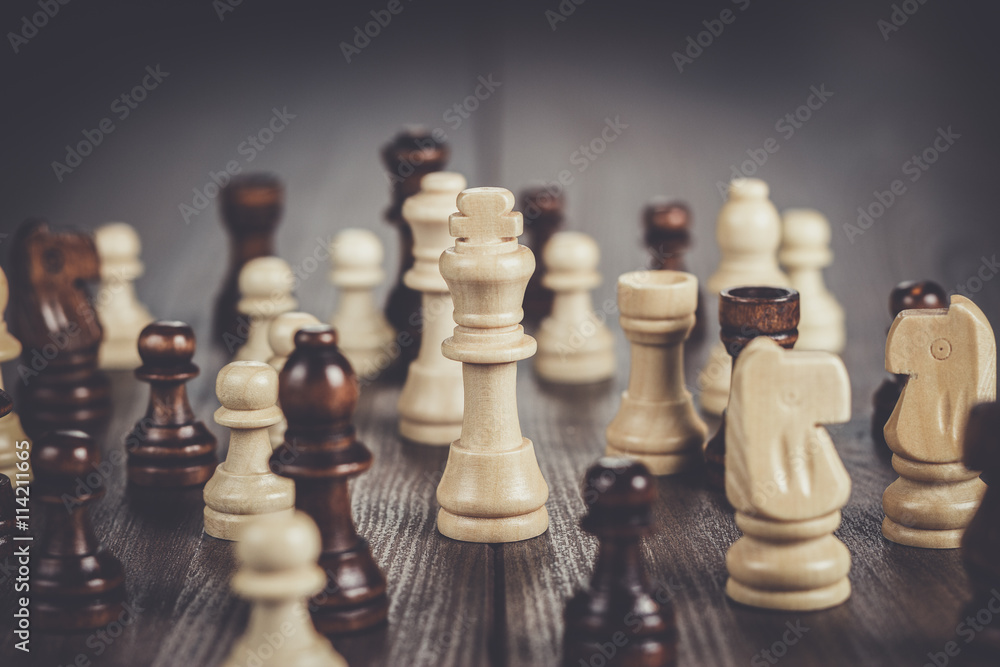 chess figures on the brown wooden table background chess figures on the brown wooden table background