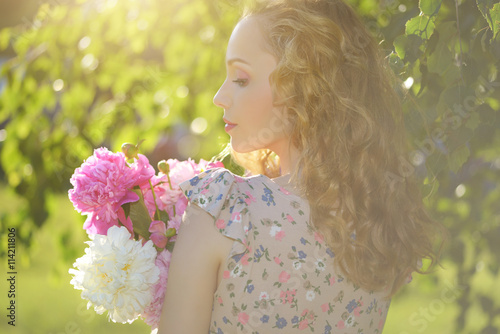 Girl with peony flowers