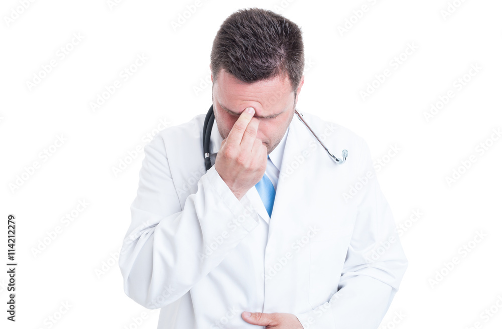 Male doctor pressing his forehead like feeling a headache Male doctor pressing his forehead like feeling a headache