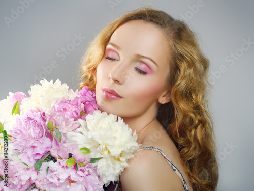 Beautiful girl with peony flowers