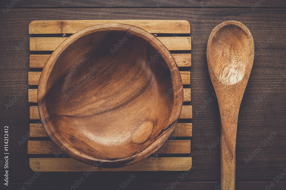 wooden salad plate and spoon on the brown table wooden salad plate and spoon on the brown table