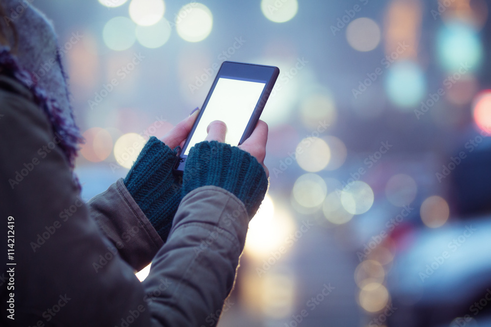 Using cellphone with defocused city lights. Using cellphone with defocused city lights.