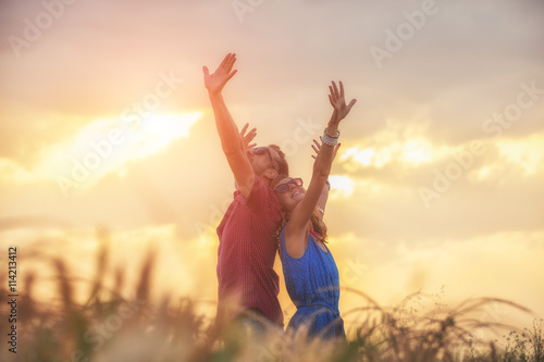 Couple enjoying outdoors in a wheat field.