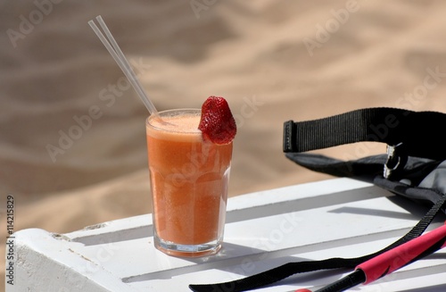 Glass of orange juice with strawberry photo