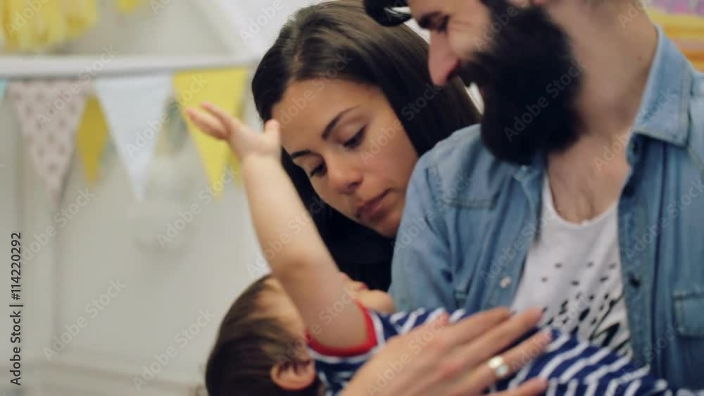 Happy father playing with baby on his hands. Communication between parents and cute baby