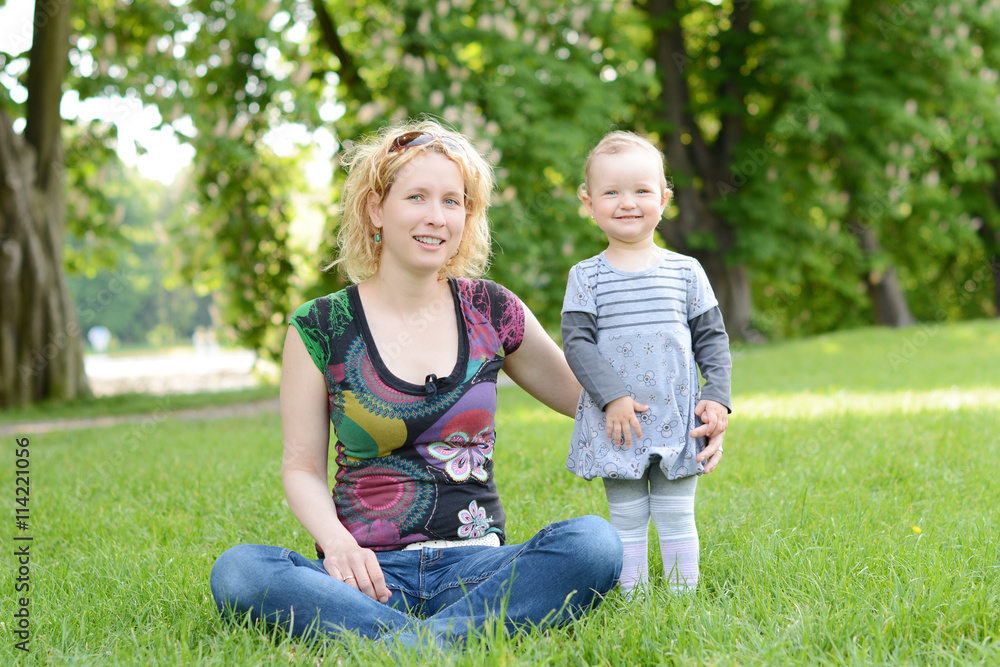 Fototapeta premium Beautiful young woman with her baby in the park.