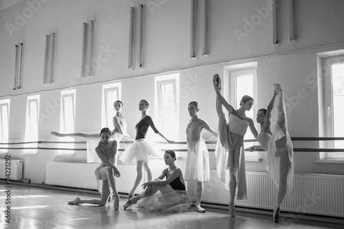 Fototapeta Naklejka Na Ścianę i Meble -  The seven ballerinas at ballet bar