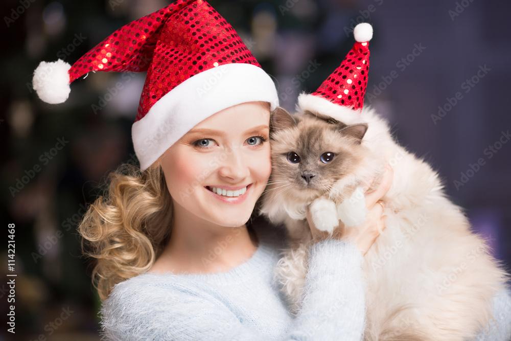 Fototapeta premium Christmas party, winter holidays woman with cat. New year girl.