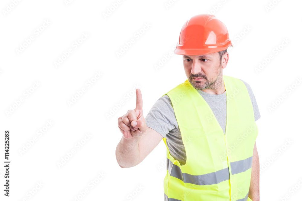 Mature attractive builder with hard hat pointing on something