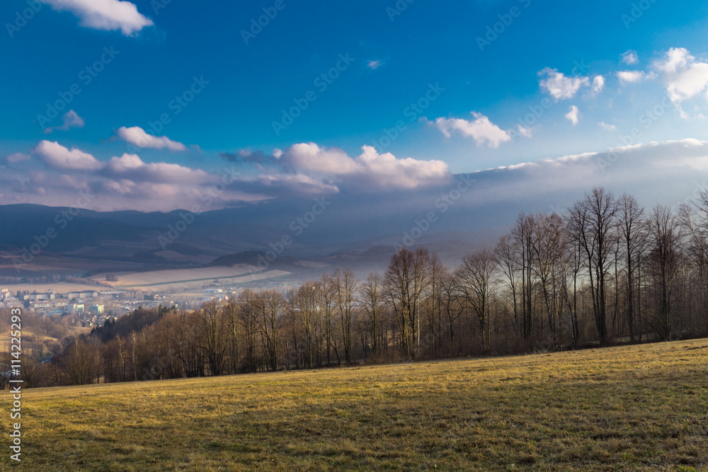 Summer landscape with sunrise and the dark blue sky in mountains