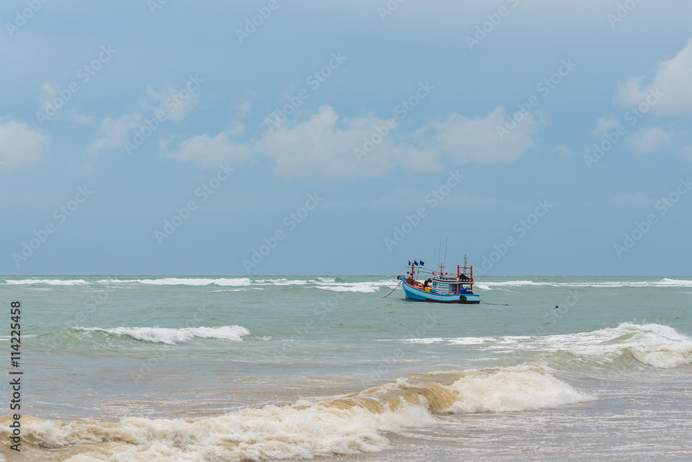 Fishing boat in a storm approaching.