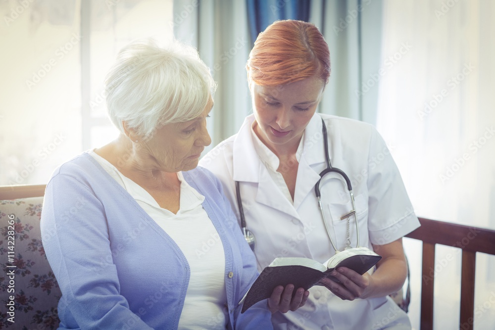 Doctor and patient reading a book Doctor and patient reading a book