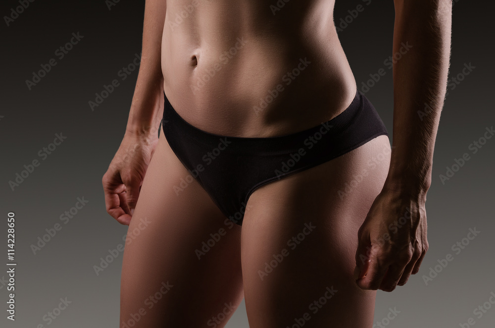 Naklejka premium Female sexy body in black underwear. Woman body care.
