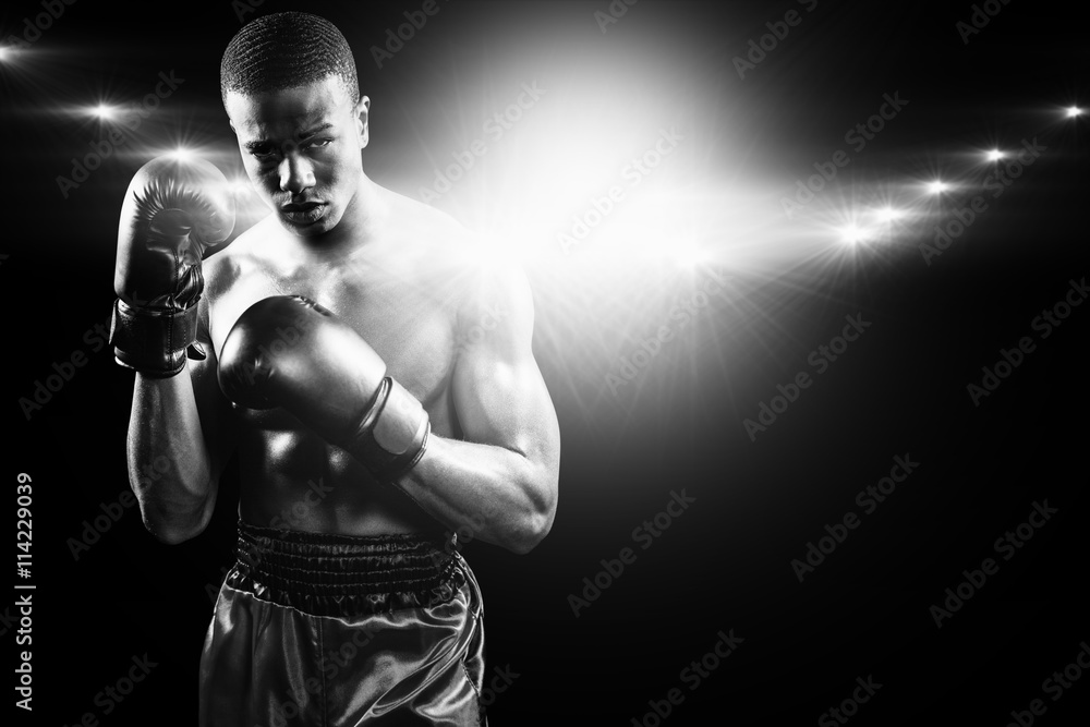Composite image of portrait of boxer performing uppercut