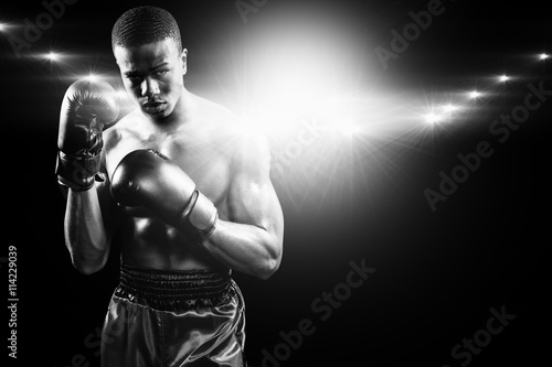 Composite image of portrait of boxer performing uppercut © vectorfusionart