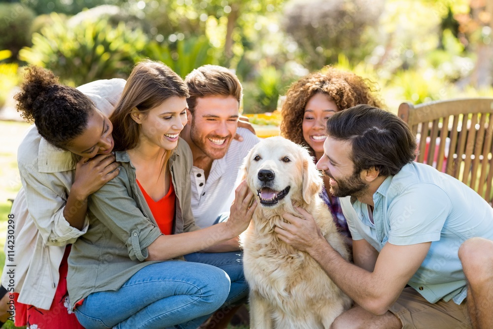 Group of happy friends sitting together with the dog Group of happy friends sitting together with the dog