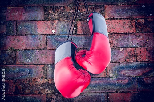 Composite image of boxing gloves attached to white background © vectorfusionart