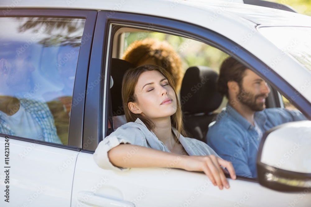 Beautiful woman relaxing in car with friends Beautiful woman relaxing in car with friends
