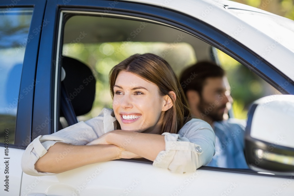Thoughtful woman looking out from car window Thoughtful woman looking out from car window