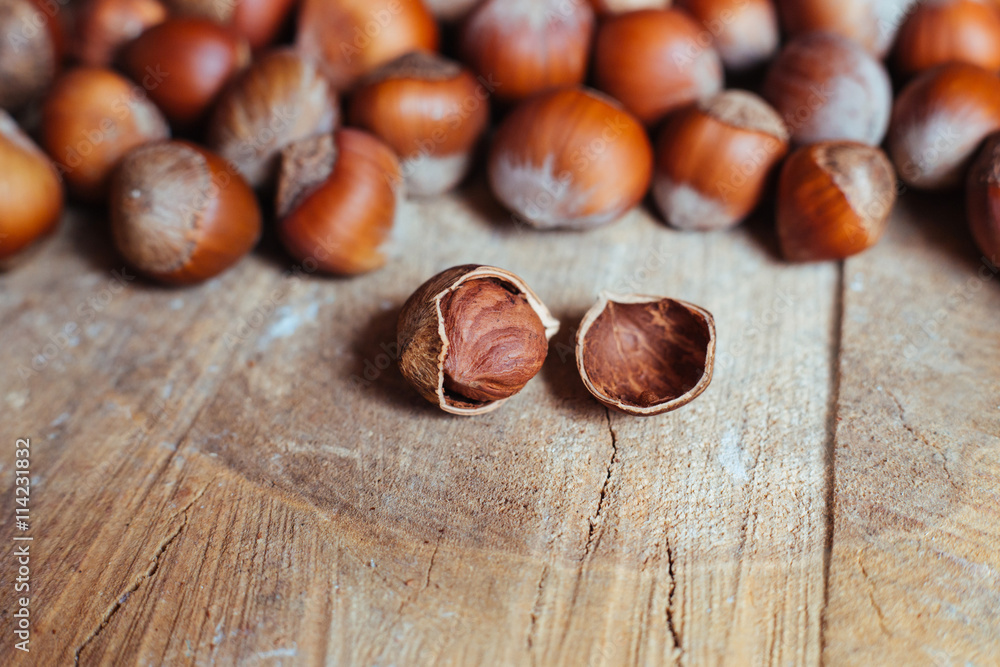 Fototapeta premium Hazelnuts on rustic background