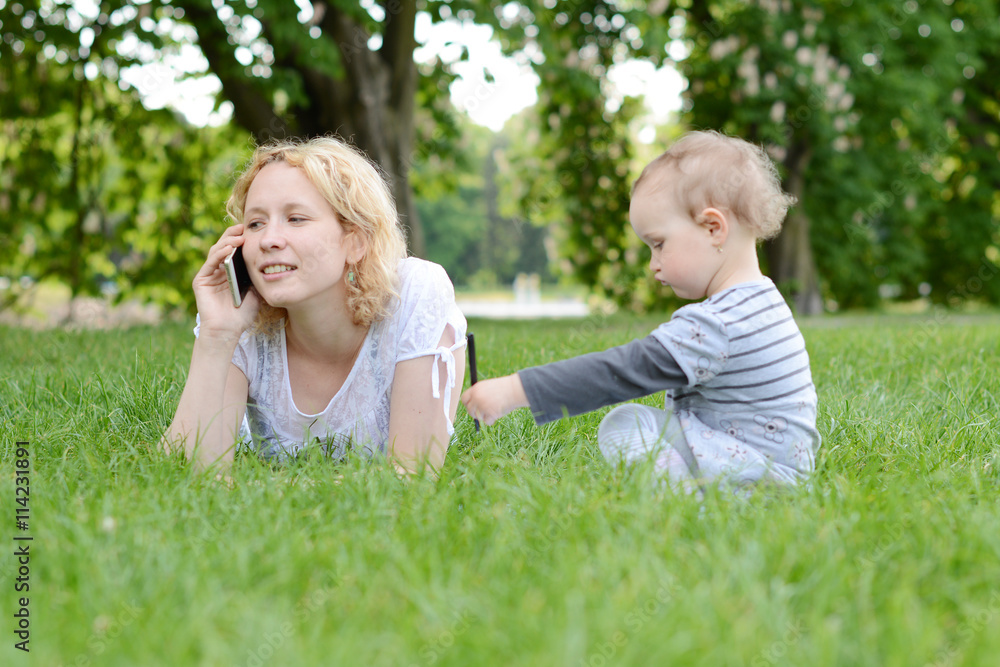 Beautiful young woman with her baby in the park. Beautiful young woman with her baby in the park.