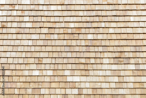 Several wood cedar shingles for siding or roofs.
