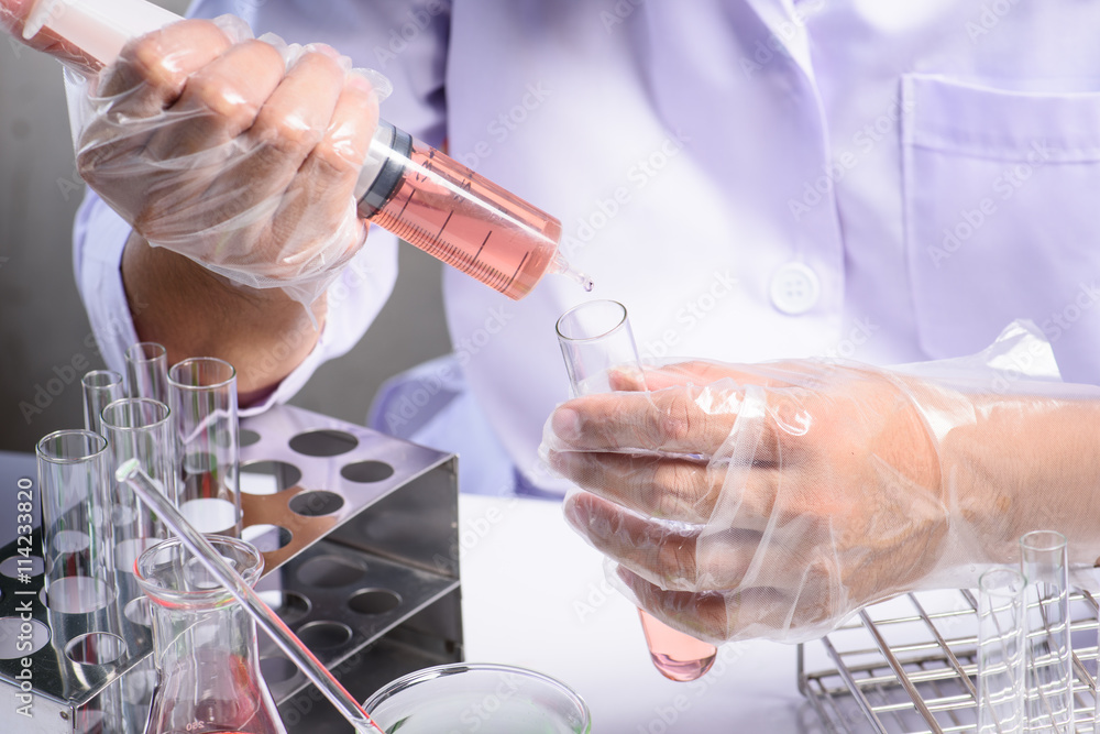 Conical flask in scientist hand with lab glassware background, L Conical flask in scientist hand with lab glassware background, L