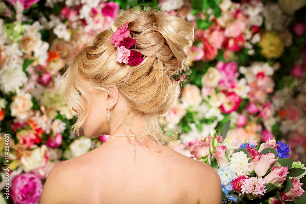 Fototapeta premium Wedding hairstyle a young girl. Bride. Woman with Flowers in her