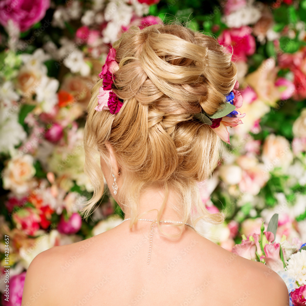Naklejka premium Wedding hairstyle a young girl. Bride. Woman with Flowers in her