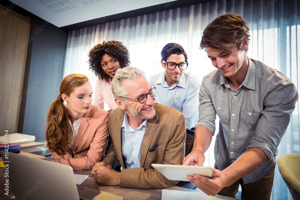 Fototapeta premium Business people discussing over digital tablet