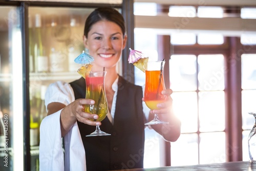 Waitress handing over cocktails