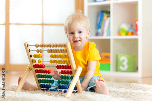 child boy playing with counter toy at home
