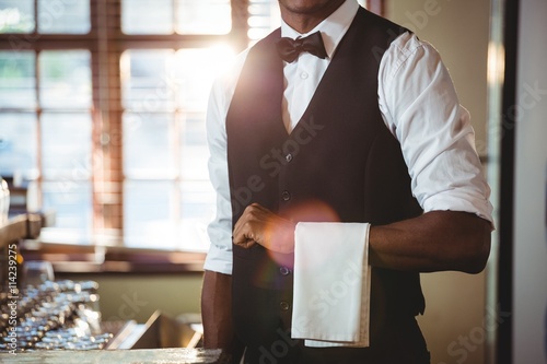 Bartender with napkin draped on his hand photo