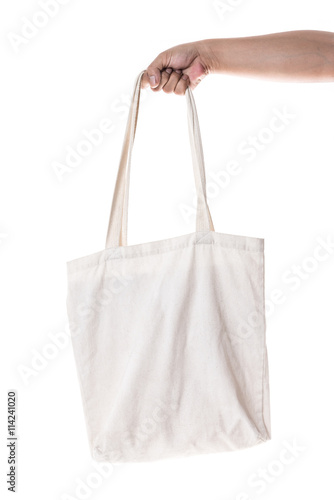 Hand holding cotton eco bag on white background