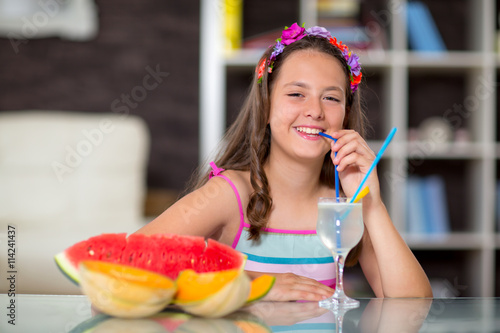 Summer refreshment..The girl drinking lemonade in front of her watermelon and melon