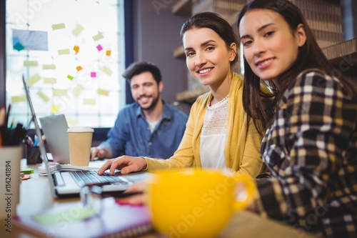 Happy business colleagues working at desk 