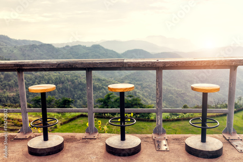 Lonely  empty chairs on a deck at sunrise ready for treveler to photo